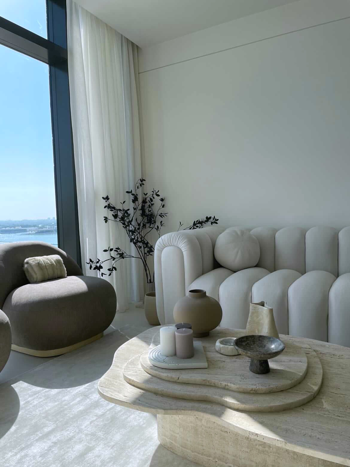 Organic shape natural travertine 3 layered coffee table in stunning Abu Dhabi apartment.