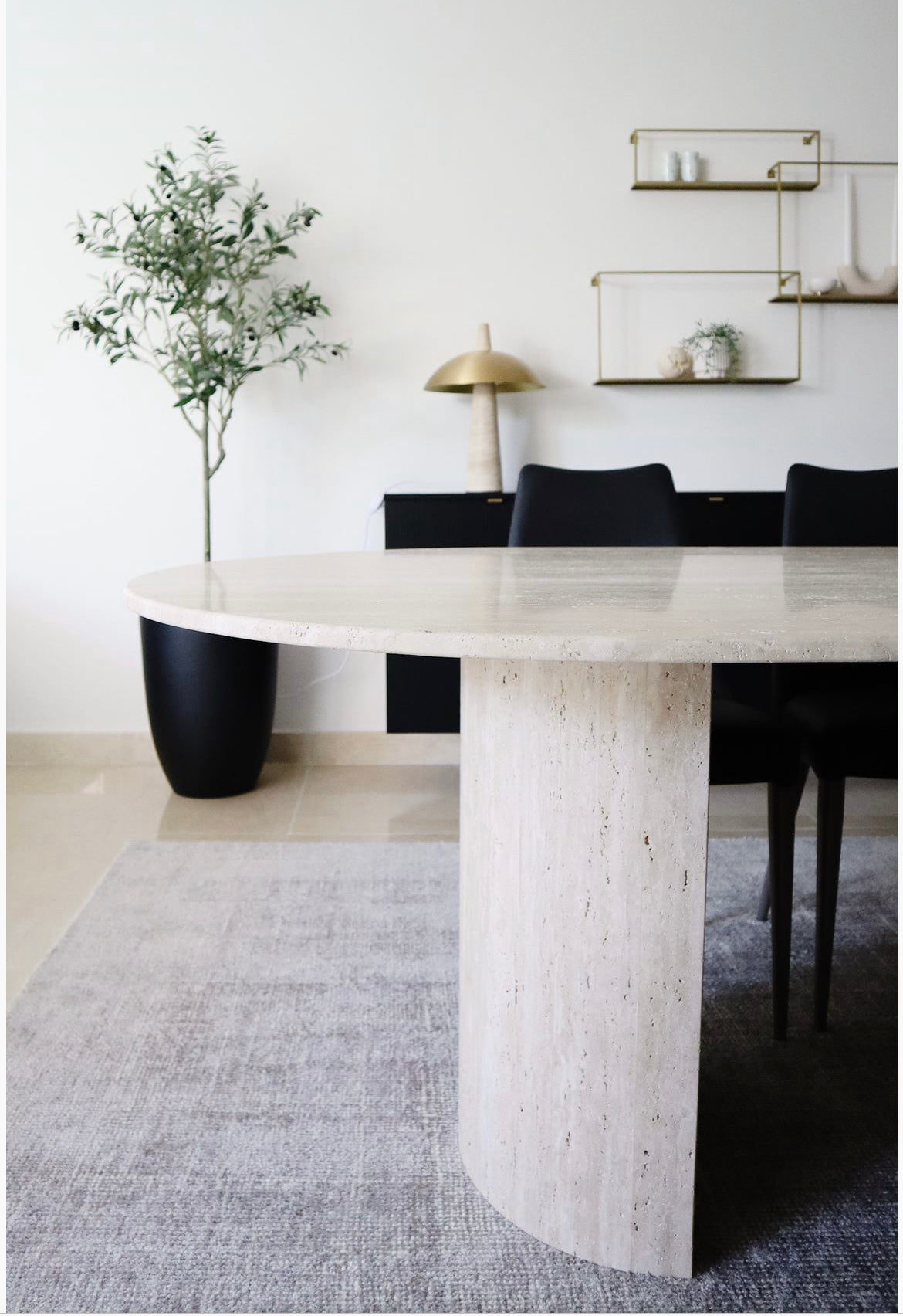 Close up of the lovely light beige natural textured travertine dining table, with half moon base.