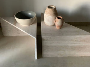 Travertine triangle coffee tables with clay pots on show