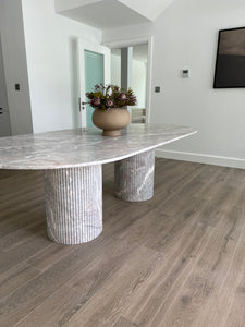 Stunning 8 seater oval top dining table with fluted cylinder bases in limited edition Fior Greek marble.