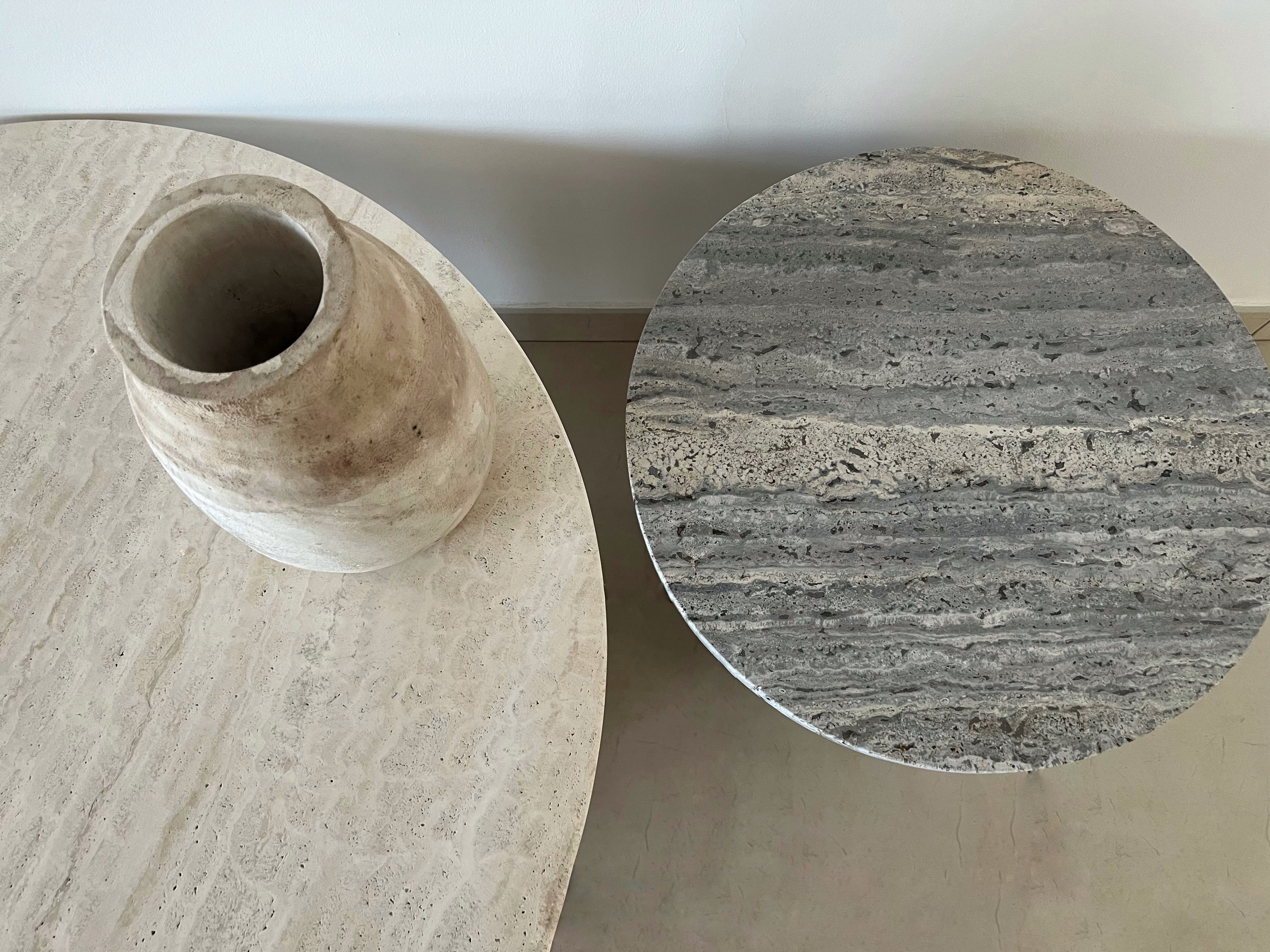 2 Beige and silver travertine round table tops.