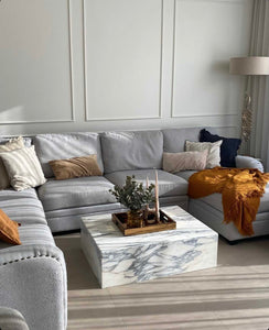 Grey and white arabascato marble cube coffee table in stylish living room.