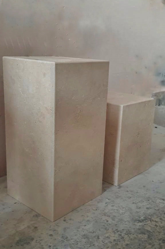 2 travertine cube plinth tables in workshop.