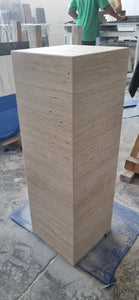 Light beige travertine tall cube plinth in natural finish.