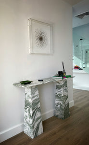 Console table with rectangle top and tapered legs in a beautiful green and white wavy marble.