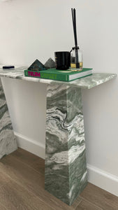 Close up of the vein matched tapered legs on the Zancos green and white marble console.